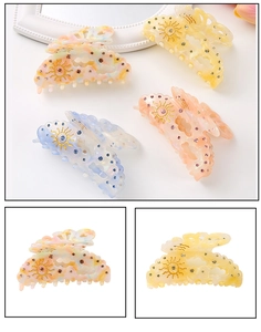 Detail of hollow acetate hair claws with rhinestone sun patterns in mixed colors