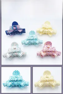 Détails de la texture dentelle des pinces à cheveux en forme de nœud en divers coloris