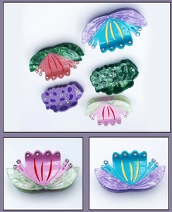 Detail of acetic acid lotus hair claw clips with rhinestones in various colors