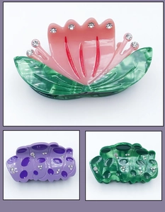Detail of acetate lotus hair claws with sparkling rhinestones and floral tulip designs