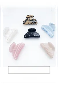 Flat lay of six large acetate claw clips in various colors with delicate rhinestone accents