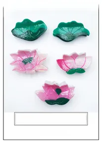 Detailed macro view of large lotus and lily leaf acetate hair clips with gradient colors