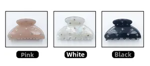 Detailed look at star-patterned hair claw clips in pink, white, and black colors