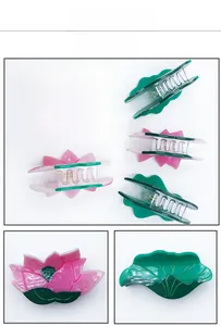 Macro detail of lotus and leaf acetate hair claw clips with gradient texture and serrated teeth