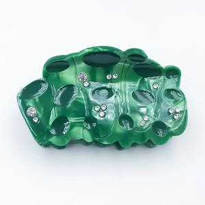 Elegant lotus acetic acid hair claw with green marble texture and sparkling rhinestones