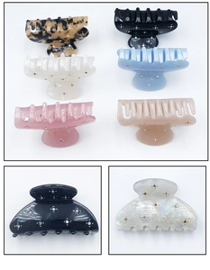 Close-up of sparkling rhinestone hair claw clips in various colors for elegant styling