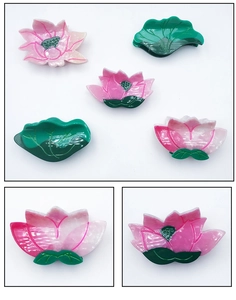 Detailed close-up of pink lotus and green leaf acetate hair claw clip textures
