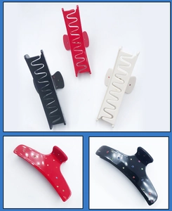 Close-up of acetic acid hair claw clip with colorful rhinestones in red and black