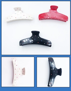 Detailed views of acetate shark hair claws with colorful rhinestones in black white and red