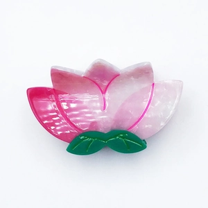 Pink and white gradient lotus hair claw clip with green leaves in acetate material