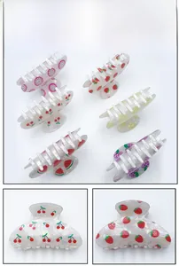 Detail view of medium PVC fruit hair claws with various colorful patterns and strong grip