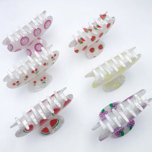 Set of six colorful fruit-patterned PVC hair claws featuring strawberry and cherry designs