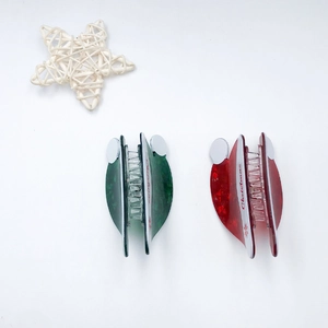Glittery Christmas hat hair claws in red and green set with snowflake patterns