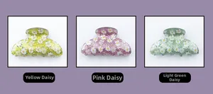 Three colorful acrylic daisy hair claws in yellow, pink and green with glitter finish