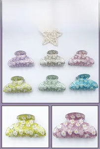 Detail shot of multi-colored acrylic daisy hair claws with glitter finish in six colors