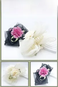 Detail view of large mesh flower hair claw with pearl chains and satin ribbons