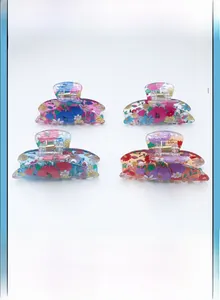 Detail view of 4-piece set floral printed PVC hair claw clips in various colors