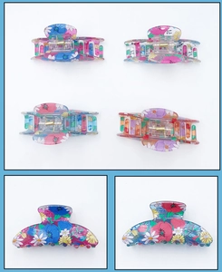 Detail view of floral print hair claws with intricate daisy patterns and metal springs