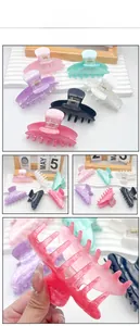 Detailed macro of acrylic hair claw clips featuring marble textures and durable metal springs