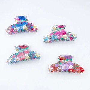 Set of four floral print PVC hair claws in pink, teal, blue and orange shades