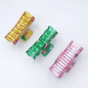 Three square Christmas acrylic hair claws with pink, green, and gold glitter finish