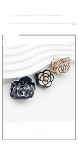 Detail of camellia hair clips with pearls, sequins, and hollow rose gold outlines