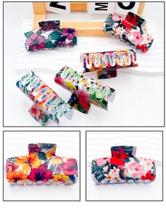 Detailed side view of large PVC hair claw clips with tropical hibiscus floral print