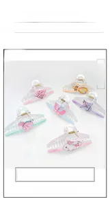Detail view of large acrylic hair claws with elegant printed fan and butterfly patterns
