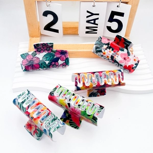 Five-pack large floral resin hair claws with tropical hibiscus and palm leaf patterns