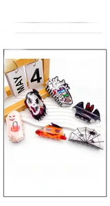 Detail of Halloween acrylic hair clips featuring ghost pumpkin and bat holiday patterns