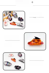 Detailed view of Halloween acrylic hair claws featuring pumpkin and bat motifs