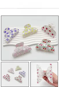 Detailed set of five fruit print PVC hair claws including strawberry and cherry patterns