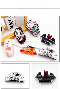 Detail view of 6-piece acrylic Halloween hair clips featuring pumpkin, bat and ghost motifs
