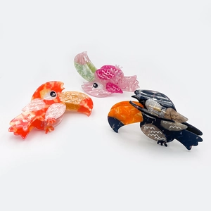 Spliced acetate parrot hair claws in orange, purple and blue with gold springs