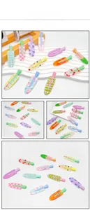 Close-up of colorful acrylic fruit hair clips with peach and cherry patterns