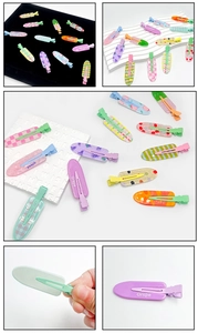 Detailed view of candy-colored resin hair clips with fruit patterns like peach and cherry