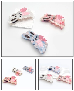 Close-up of cute acetate rabbit hair claws with bow details in three colors