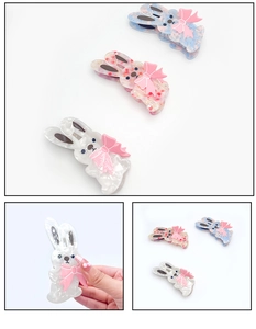Detail of acetate hair clips in rabbit shape with cute pink bows in three colors