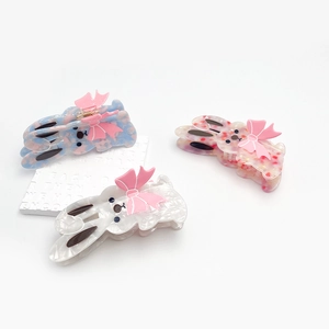 Three acetate rabbit hair clips with pink bows in blue, pink, and white colors