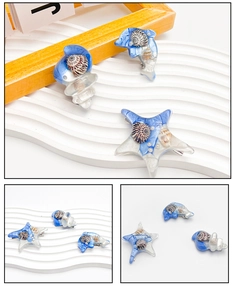 Détail des barrettes étoile de mer et dauphin avec coquillages en résine et perles blanches