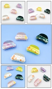 Detail of various colorful ocean-themed hair claws with coral and starfish patterns