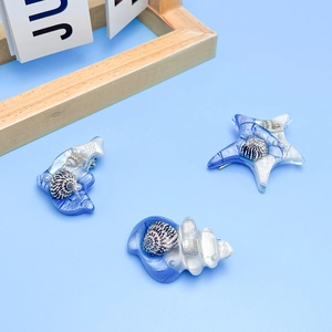 Pinces à cheveux étoile de mer et coquillage avec perles et résine bleu estival