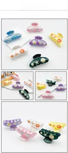 Detailed views of ocean-themed hair claws featuring starfish and shell patterns in various colors