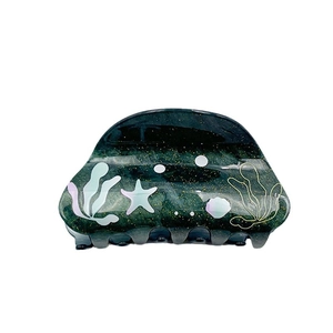 Ocean themed green marble hair claw with starfish and seaweed patterns for women