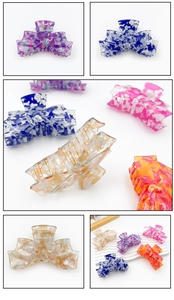 Close-up of five colorful marble patterned acetate hair claws for daily styling