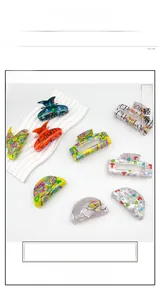 Close-up of acrylic hair clips with school themed prints and letter patterns