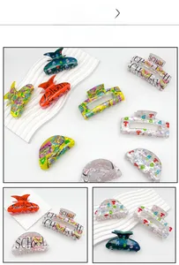 Detailed view of various acrylic hair claws with graffiti letters and butterfly patterns