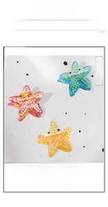 Three-piece acetate starfish hair claws with colorful polka dots and 3D eye details