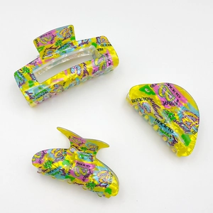 Yellow acrylic hair claws with graffiti back to school patterns and cut-out designs