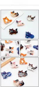 Detailed views of cat and dog shaped acetate hair claws in various marble textures